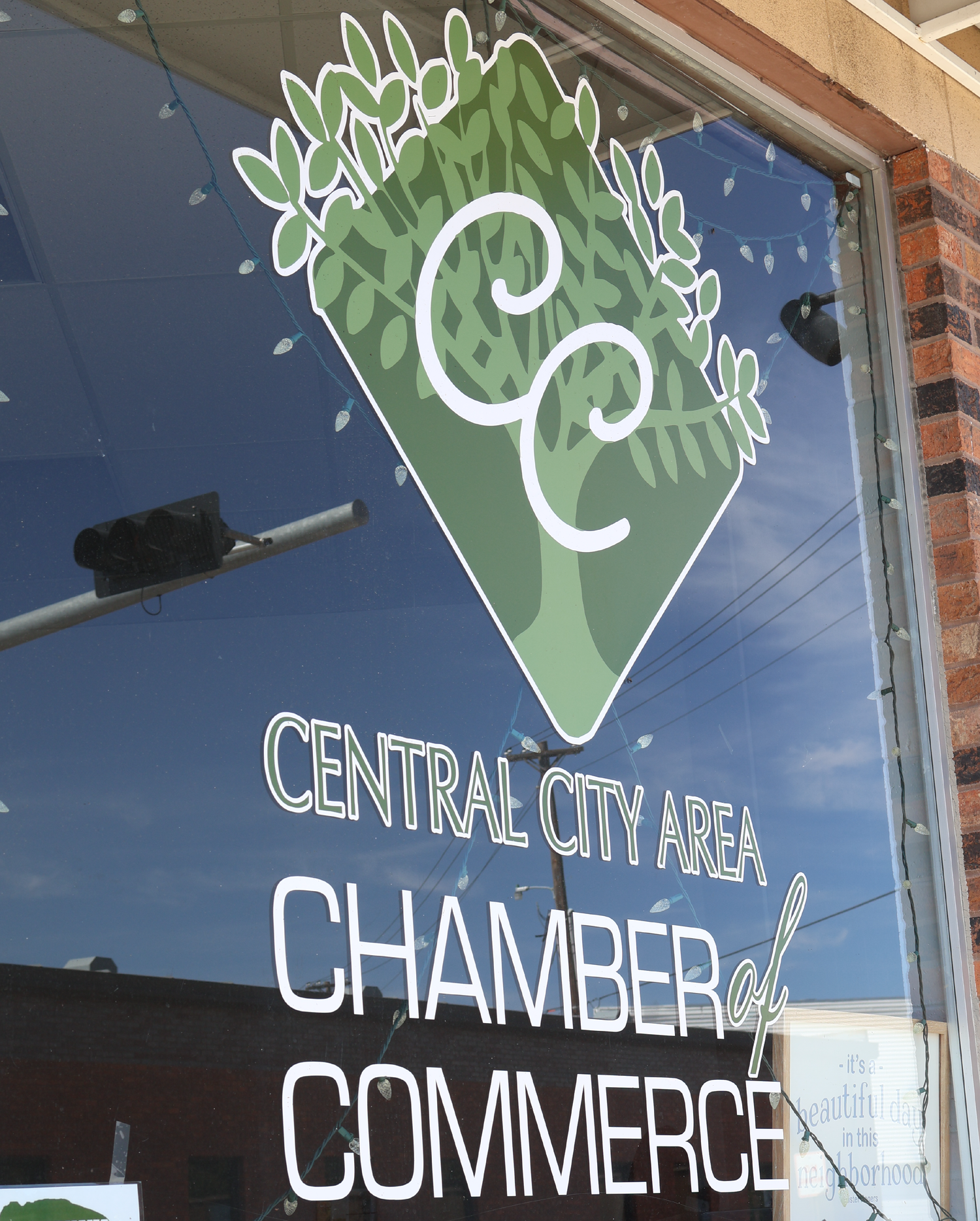 Glass window at the Central City Area Chamber of Commerce with their logo on it